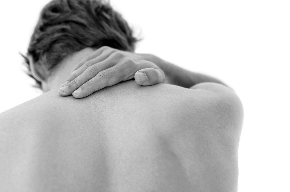 A man with a sore neck helped by our Brookfield Chiropractor
