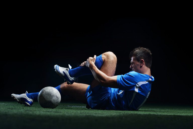 soccer player stretching before a game