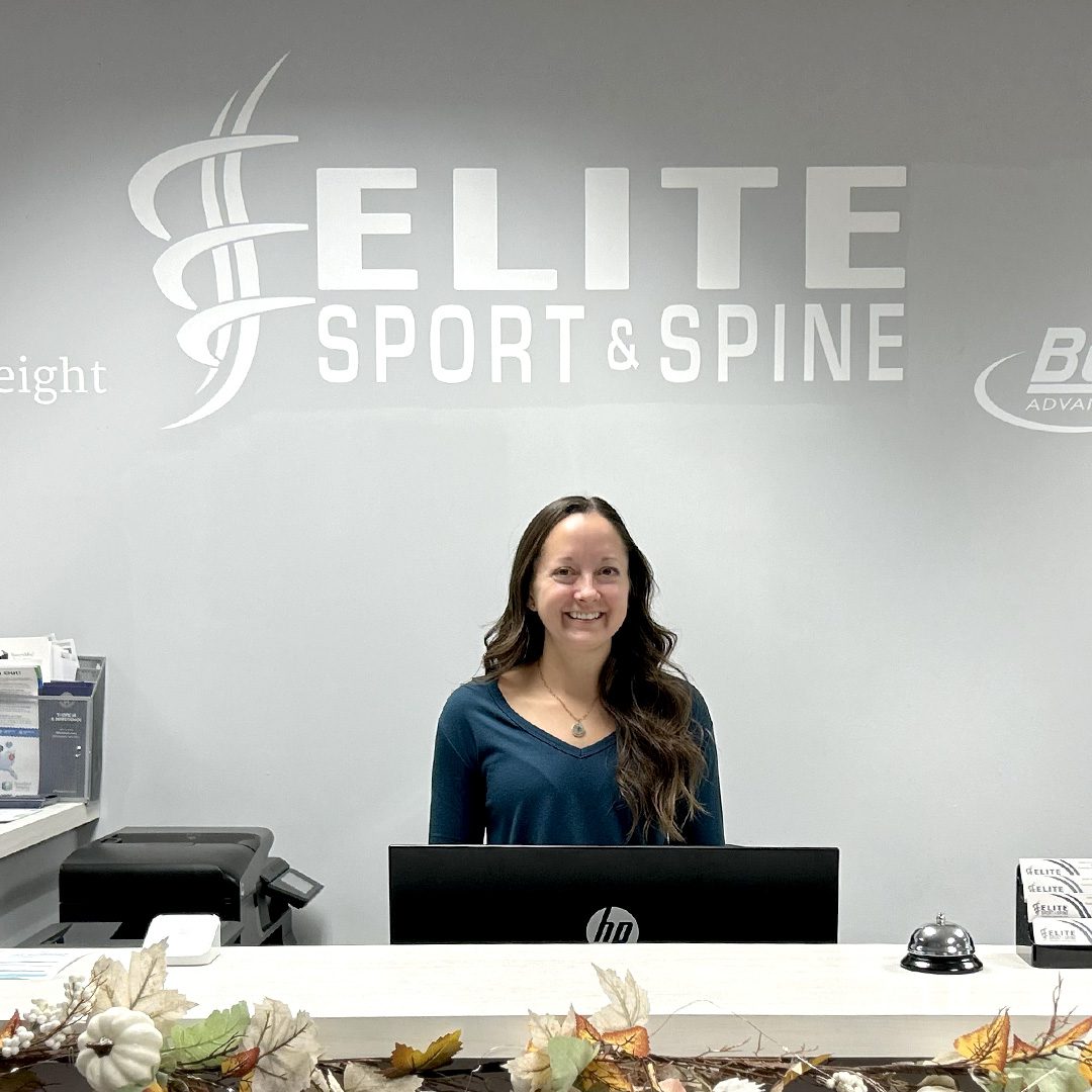 office administrator welcoming new patients to chiropractor